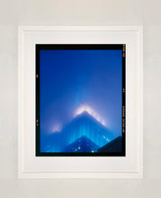 Load image into Gallery viewer, &#39;NOMAD II (Film Rebate)&#39;, New York. Richard Heeps has photographed the iconic Empire State building in the mist. The NOMAD sequence of photographs capture the art deco architecture illuminated by changing colours, and is part of Richard&#39;s street photography portfolio which depict the colour, fabric and structure of cities with distinct style. This 6x7 format edition is bordered by the Kodak film rebate. 