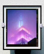Load image into Gallery viewer, &#39;NOMAD VIII (Film Rebate)&#39;, New York. Richard Heeps has photographed the iconic Empire State building in the mist. The NOMAD sequence of photographs capture the art deco architecture illuminated by changing colours, and is part of Richard&#39;s street photography portfolio which depict the colour, fabric and structure of cities with distinct style. This 6x7 format edition is bordered by the Kodak film rebate. 