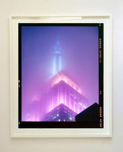 'NOMAD VIII (Film Rebate)', New York. Richard Heeps has photographed the iconic Empire State building in the mist. The NOMAD sequence of photographs capture the art deco architecture illuminated by changing colours, and is part of Richard's street photography portfolio which depict the colour, fabric and structure of cities with distinct style. This 6x7 format edition is bordered by the Kodak film rebate. 