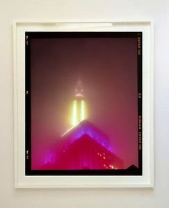 NOMAD VII (Film Rebate), New York, photography by Richard Heeps capturing the iconic Empire State building in the mist. Part of a sequence of photographs capturing the art deco architecture illuminated in changing colours. This 6x7 format edition is bordered by the Kodak film rebate. This artwork is part of Richard's portfolio of street photography he is building up which depict the colour, fabric and structure of cities with distinct style