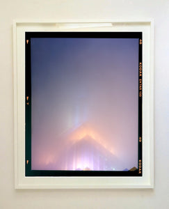 'NOMAD VI (Film Rebate)', New York. Richard Heeps has photographed the iconic Empire State building in the mist. The NOMAD sequence of photographs capture the art deco architecture illuminated by changing colours, and is part of Richard's street photography portfolio which depict the colour, fabric and structure of cities with distinct style. This 6x7 format edition is bordered by the Kodak film rebate. 
