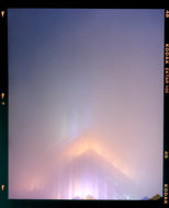 'NOMAD VI (Film Rebate)', New York. Richard Heeps has photographed the iconic Empire State building in the mist. The NOMAD sequence of photographs capture the art deco architecture illuminated by changing colours, and is part of Richard's street photography portfolio which depict the colour, fabric and structure of cities with distinct style. This 6x7 format edition is bordered by the Kodak film rebate. 