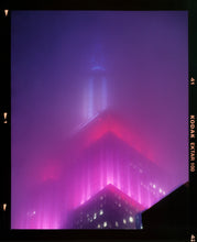 Load image into Gallery viewer, &#39;NOMAD V (Film Rebate)&#39;, New York. Richard Heeps has photographed the iconic Empire State building in the mist. The NOMAD sequence of photographs capture the art deco architecture illuminated by changing colours, and is part of Richard&#39;s street photography portfolio which depict the colour, fabric and structure of cities with distinct style. This 6x7 format edition is bordered by the Kodak film rebate. 