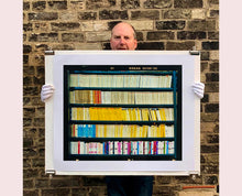 Load image into Gallery viewer, As part of Richard Heeps&#39; series, A Short History of Milan, The Last Kiss features a series of yellow, blue and pink Italian books.