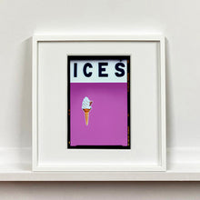 Load image into Gallery viewer, White framed photograph by Richard Heeps.  At the top black letters spell out ICES and below is depicted a 99 icecream cone sitting left of centre against plum coloured background.  
