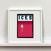 Load image into Gallery viewer, White framed photograph by Richard Heeps.  At the top black letters spell out ICES and below is depicted a 99 icecream cone sitting left of centre against a raspberry coloured background.  