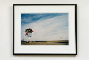 Part of the 'Dream in Colour' series, 'Roy's - Route 66' is one of Richard Heeps' classic American sign artworks featuring the road sign for Roy's Motel, which demonstrates historic Mid-Century Modern Googie architecture. This photograph was capture on the National Trails Highway of U.S. Route 66, in the Mojave Desert town of Amboy in San Bernardino County, California.