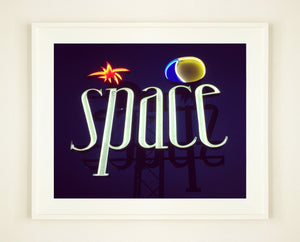 'Space', features neon lettering against an inky blue sky. The subject is a roadside sign taken in Ibiza during the final year of the iconic super club.