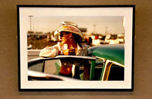 'Sun Kissed Wendy', from Richard Heeps' 'Man's Ruin' Series. This artwork is part of a sequence capturing Wendy at the Rockabilly Weekender, Viva Las Vegas. This cinematic portrait of Wendy captures her kissed by the sunset.