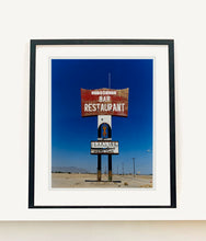 Load image into Gallery viewer, This giant isolated roadside sign set against a vast blue sky is a remnant of &#39;The Sundowner Bar and Restaurant&#39; of the motel which is sadly no more. This photograph, part of Richard Heeps&#39; &#39;Salton Sea&#39; series captures the landscape of the western side of the lake.