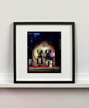 Load image into Gallery viewer, The traditional Italian Tobacconist shop, here in a Swiss Cottage style building set against a vast urban apartment block.