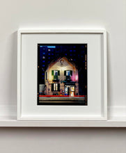 Load image into Gallery viewer, The traditional Italian Tobacconist shop, here in a Swiss Cottage style building set against a vast urban apartment block.