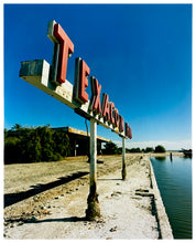 Load image into Gallery viewer, Photograph by Richard Heeps.  An old Texaco Marina sign sits next to California&#39;s largest marina.  Set against a deep blue sky.