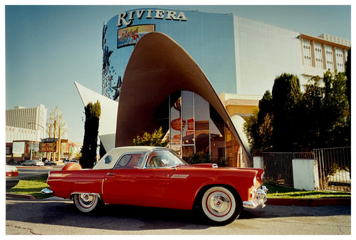 Photograph by Richard Heeps. A bright red Ford Thunderbird, parked up outside the La Concha Motel in Las Vegas.