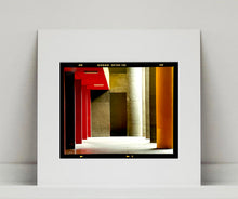 Load image into Gallery viewer, Italian designed brutalist architecture in Milan, featuring red and yellow pillars. 