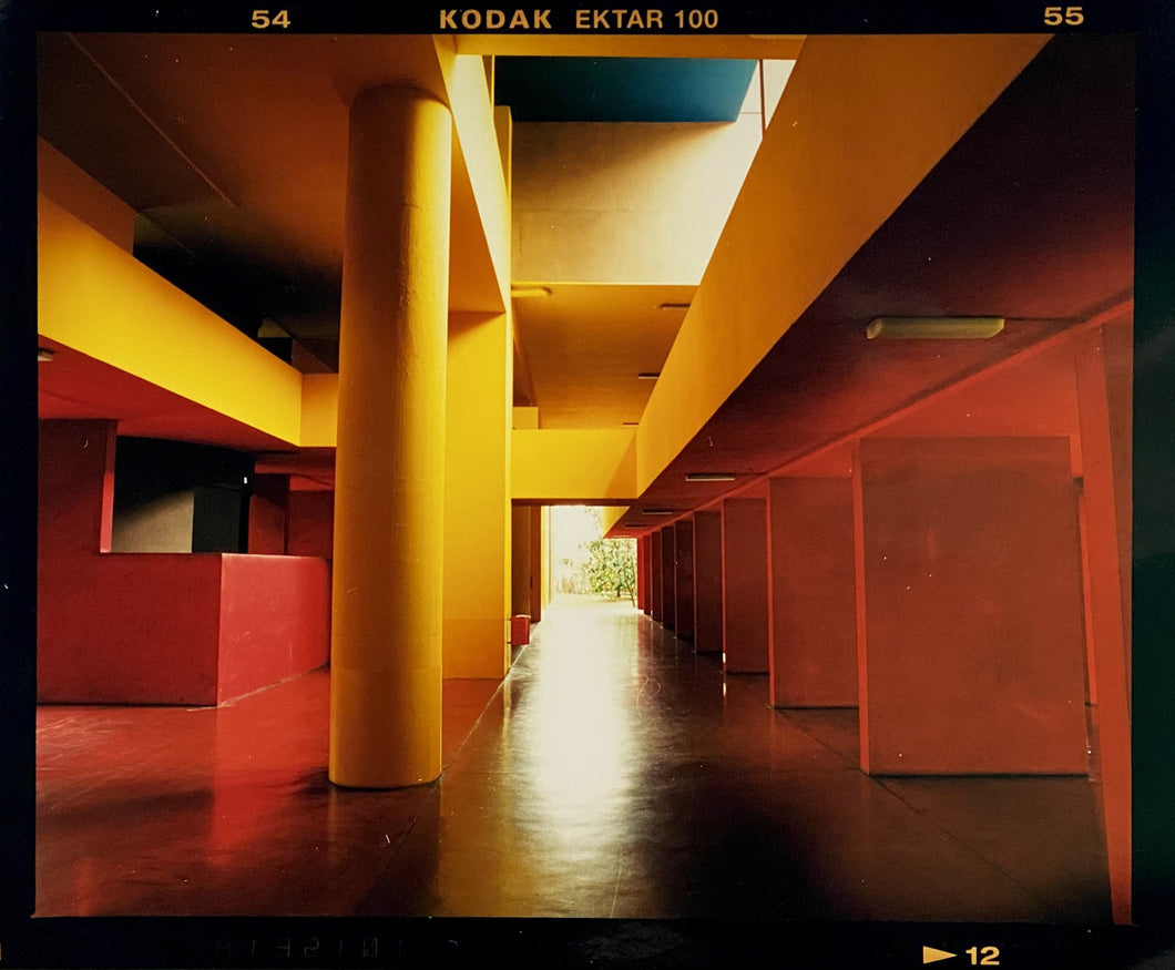 Italian designed brutalist architecture in Milan, featuring red and yellow pillars. 