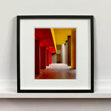 Load image into Gallery viewer, Monte Amiata housing, Gallaratese Quarter, Milan. Red and yellow brutalist architecture street photography by Richard Heeps Framed in black.