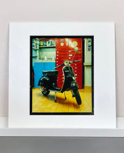 Load image into Gallery viewer, A black vespa against a red, blue and yellow interior. Photographed in Milan, Italy. 