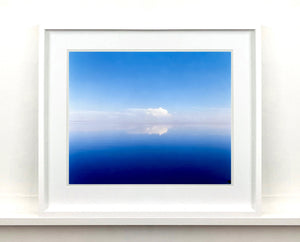 'View from Bombay Beach' looks over Salton Sea in California. Cooling shades of blue, reflection and symmetry are key to this serene waterscape. The suspended cloud which looks surreal creates a feeling of weightlessness. 