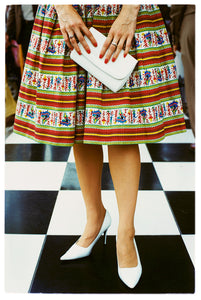 Photograph by Richard Heeps.  Vintage Goodwood, striped and patterned skirt and white stilettos. White clutch bag held as a centre piece. 