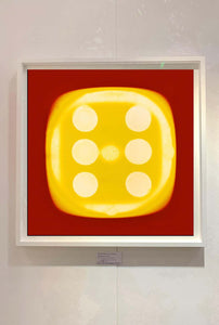 From Heidler & Heeps Dice Series, a yellow dice suspended on a red background.