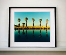 Load image into Gallery viewer, Plam trees stand tall against ombre skies in shades of blue and green in &#39;Zzyzx Resort Pool II&#39;, taken in Soda Dry Lake, California. This artwork was taken on a road trip from LA to Las Vegas. This photograph was taken on negative in 2002 but only executed in Richard&#39;s darkroom for the first time in 2017.